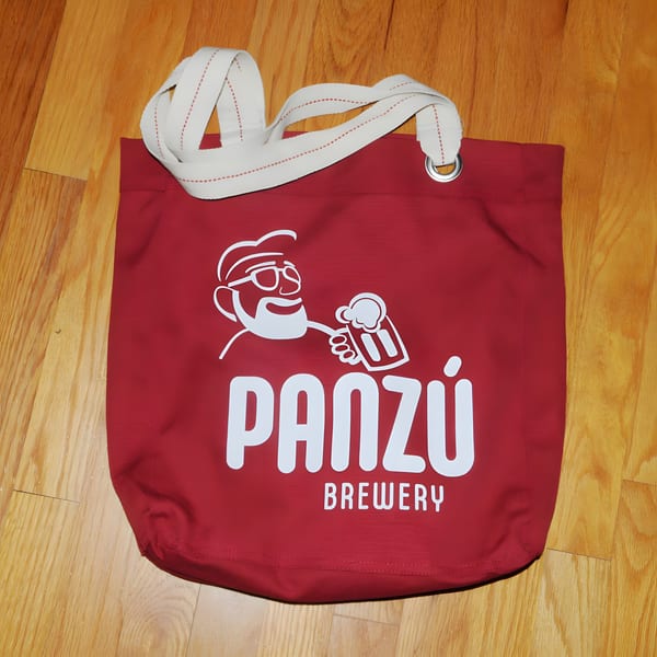 Red Panzu Brewery tote bag with a white logo of a man holding a beer mug.